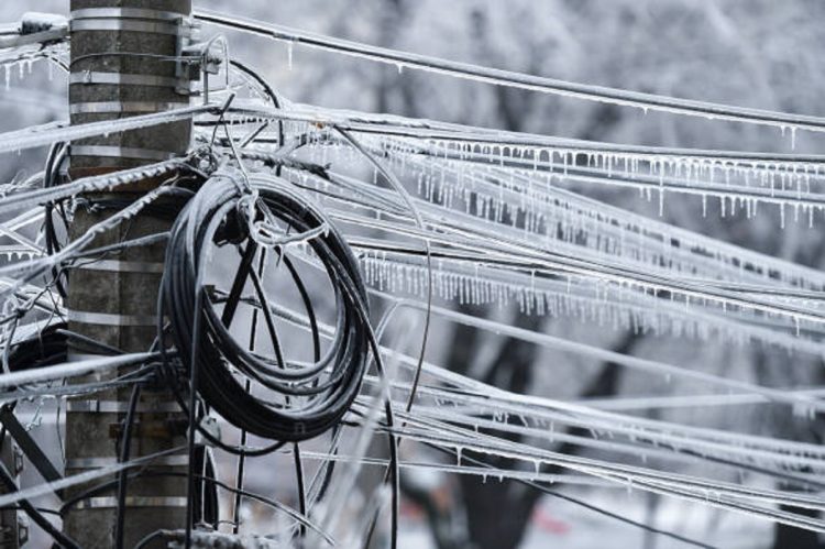Electricity cables covered in ice after frozen rain phenomenon