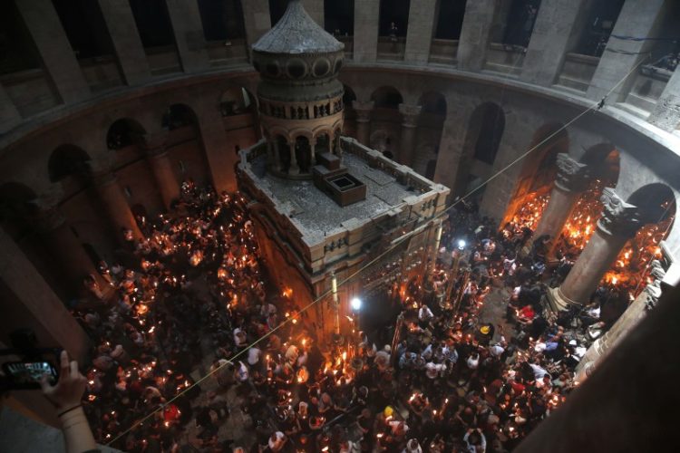 (210502) -- JERUSALEM, May 2, 2021 (Xinhua) -- Christian Orthodox worshipers hold up candles lit from the "Holy Fire" as thousands gather in the Church of the Holy Sepulchre during the Orthodox Easter ceremonies in Jerusalem's Old City, on May 1, 2021. (Photo by Muammar Awad/Xinhua)